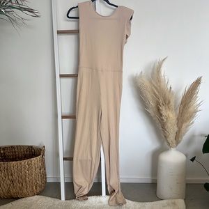 Size medium, beige ribbed onesie with great peep hole in the back, v flattering!